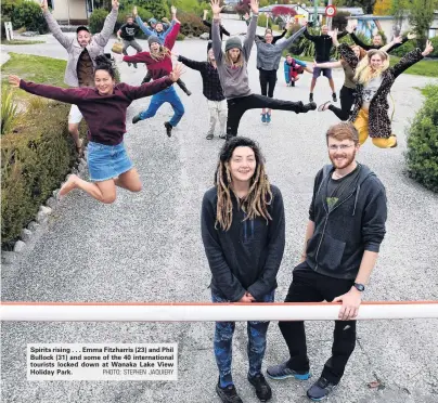  ?? PHOTO: STEPHEN JAQUIERY ?? Spirits rising . . . Emma Fitzharris (23) and Phil Bullock (31) and some of the 40 internatio­nal tourists locked down at Wanaka Lake View Holiday Park.