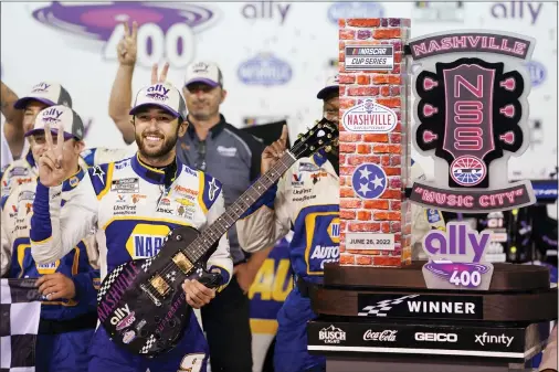  ?? MARK HUMPHREY — THE ASSOCIATED PRESS ?? Chase Elliott poses with his guitar and trophy after winning a NASCAR Cup Series race Sunday in Lebanon, Tenn.