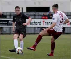  ??  ?? Conor Sutton plays the ball down the flank past Marc Ludden.