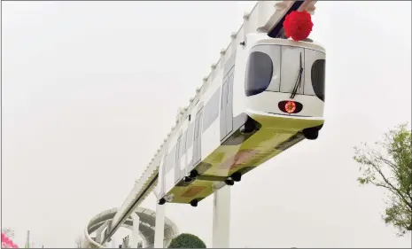  ??  ?? China’s first suspension railway line begins testing in Chengdu, Southwest China’s Sichuan Province on Monday. The railway coach’s exterior is decorated like a panda.