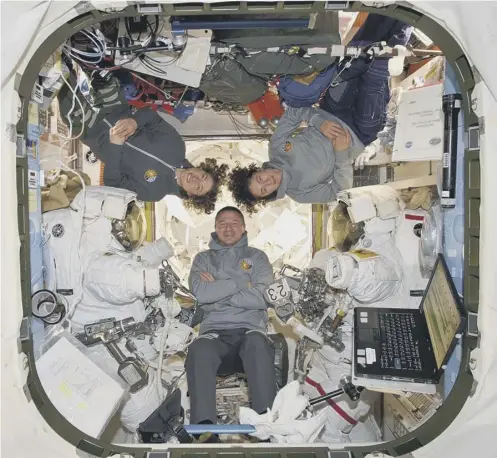  ??  ?? 0 Astronauts Christina Koch and Jessica Meir with crew mate Andrew Morgan. Below, the pair during their spacewalk