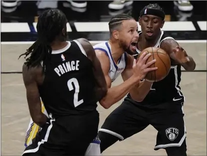  ?? PHOTOS BY KATHY WILLENS — THE ASSOCIATED PRESS ?? Brooklyn Nets forward Taurean Prince (2) and guard Caris LeVert (22) defend Golden State Warriors guard Stephen Curry (30) as Curry looks to shoot during the first quarter on Tuesday in New York.