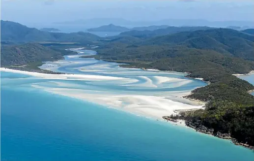  ?? THE TRAVEL CORPORATIO­N ?? Snorkel the famous Whitehaven Beach in the Whitsunday Islands during AAT KIngs’ Queensland Beaches & Reef guided holiday.