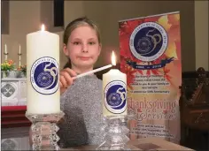  ??  ?? Sophie Fortune-Shepherd is pictured lighting the candle of hope.