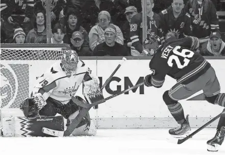  ?? BRAD PENNER/USA TODAY SPORTS ?? Capitals goaltender Charlie Lindgren makes a save against Rangers left wing Jimmy Vesey (26) on Jan. 14 at Madison Square Garden in New York.