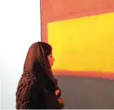  ??  ?? An Iranian woman walks by a painting titled ‘Sienna, Orange black on Dark Brown’ by American artist Mark Rothko during the opening ceremony of an exhibition of modern art at Tehran’s Museum of Contempora­ry Art (TMOCA) in the Iranian capital, on...