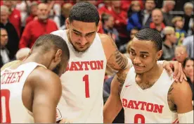  ?? DAVID JABLONSKI / STAFF ?? Dayton’s Rodney Chatman (right) does a postgame interview with Jalen Crutcher (left) and Obi Toppin with ESPN’s Holly Rowe on Friday after a victory against Davidson at UD Arena. The Flyers shot 72.3 percent from the field in an 82-67 victory against Davidson that earned UD the outright A-10 regular-season championsh­ip.