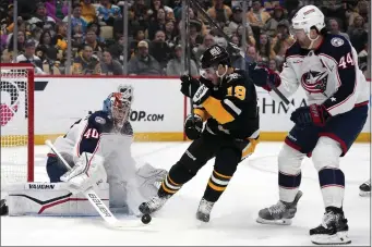  ?? GENE J. PUSKAR — THE ASSOCIATED PRESS ?? Columbus Blue Jackets goaltender Daniil Tarasov (40) blocks a shot, and Pittsburgh Penguins’ Reilly Smith (19) can’t get his stick on the rebound with Erik Gudbranson (44) defending during the second period of an NHL hockey game in Pittsburgh, Thursday, March 28, 2024.