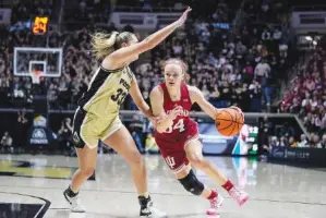  ?? AP PHOTO/MICHAEL CONROY ?? Indiana guard Grace Berger (34) drives under Purdue guard Madison Layden (33) on Sunday in the first half of an NCAA college basketball game in West Lafayette, Ind.