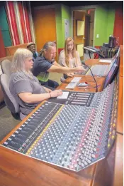  ??  ?? Scott Jarrett, center, teaches a Recording Technology Theory class to Blythe Brooks, left, and Annie Haynie at Benildus Hall on the campus of the Santa Fe University of Art and Design. Observing is Fred Simpson, who teaches African drumming at the...