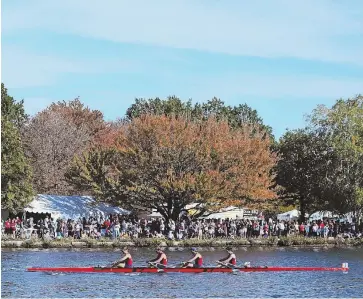  ?? STAFF PHOTO BY ANGELA ROWLINGS ?? GREAT DAY FOR BOAT WATCHING: Spectators line the bank of the river to watch the final day of the Head of the Charles Regatta yesterday.