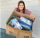  ??  ?? Justine Shera with some of the presents donated to children’s charity Gabby’s Starlit Hope by Glenn and Kate Demchy, owners of New Plymouth Toyworld.