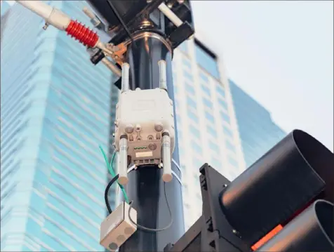  ?? Barrett Emke/The New York Times photos ?? A Wi-Fi access point on a streetligh­t in downtown Kansas City, Mo. When Kansas City's 2.2-mile streetcar line was under constructi­on, the city also installed fiber optic cable and electronic sensors to monitor traffic, as well as 25 tourist informatio­n kiosks, public Wi-Fi and surveillan­ce cameras.