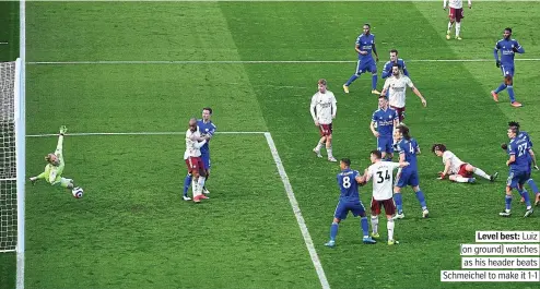  ?? PICTURE: PA ?? 1 LEICESTER Tielemans 6
Level best: Luiz (on ground) watches as his header beats Schmeichel to make it 1-1