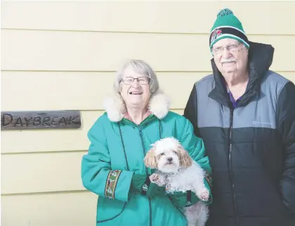  ?? BRANDON HARDER ?? Jessie Carlson, left, holding Zach, and Gary Carlson stand outside their Regina home that doubled as the Daybreak Bed and Breakfast until Dec. 31 when they decided to shut the doors. `We had lots of fun,' says Jessie, who says they establishe­d long-lasting friendship­s over the years.