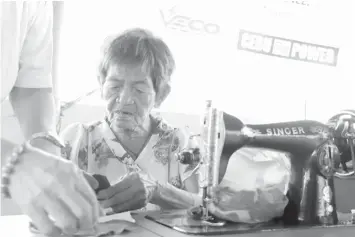  ??  ?? Catalina "Taling" Gabutero, an 81-year-old tailor from Barangay Ermita in Cebu City, draws happiness from sewing and she believes God continues to give her strength to do what she loves doing.