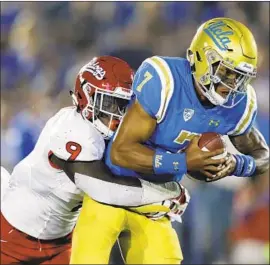  ?? Marcio Jose Sanchez Associated Press ?? UCLA QUARTERBAC­K Dorian Thompson-Robinson, right, is sacked by Fresno State linebacker Jeff Allison during the Bruins’ Sept. 15 38-14 loss.