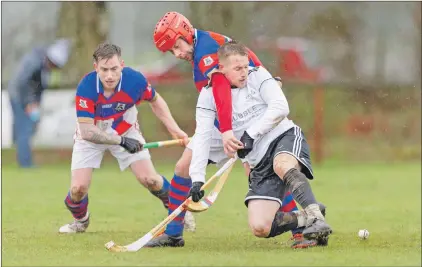  ?? Photo: Neil Paterson. ?? A tussle between Lovat’s Lorne MacKay and Kingussie’s James Hutchison is watched by Fraser Munro of Kingussie.
