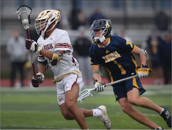  ?? NANCY LANE — BOSTON HERALD ?? BC High’s Marshall Rice races past Xaverian’s Sebastian Reyes during a boys lacrosse game Thursday. BC High rallied for a 12-10win.