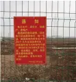  ?? YILEI SUN Reuters ?? A GOVERNMENT announceme­nt of a land request is seen on a fence on the land secured by Tesla for its Gigafactor­y in Shanghai, China. |