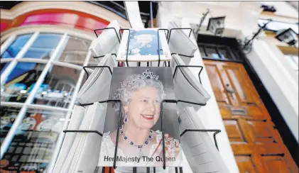  ?? Kirsty Wiggleswor­th The Associated Press ?? Postcards with pictures of Queen Elizabeth II were displayed for sale Wednesday, the queen’s 95th birthday in Windsor, England.