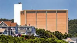  ?? JOHN TLUMACKI/GLOBE STAFF ?? The Pilgrim nuclear reactor rose in the distance over homes near Priscilla Beach on Cape Cod Bay.