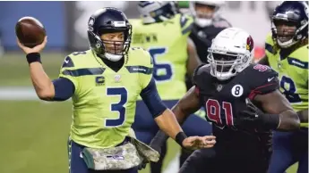  ?? AP ?? Seahawks quarterbac­k Russell Wilson passes under pressure from the Cardinals’ Michael Dogbe on Thursday.