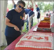  ?? NEWS PHOTOS MO CRANKER ?? Left: Five-year-old Brinley Hudson paints during the Canada Day celebratio­n at Kin Coulee Park. Above: Anne Carrier cuts a Canada 151 cake Sunday afternoon.