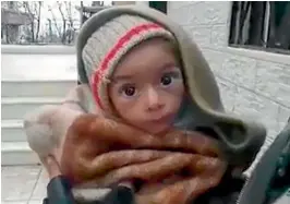  ?? PHOTO: REUTERS ?? A toddler is held up to the camera in this still image taken from video said to be shot in Madaya where warnings of widespread starvation are growing.