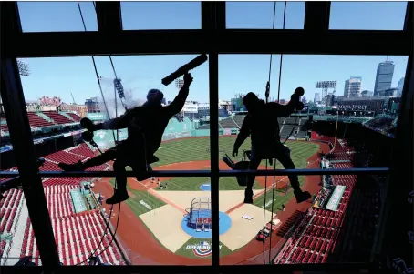  ?? ?? Window washers clean the NESN booth glass during the final preparatio­ns for 2023 Opening Day at Fenway Park in Boston on Wednesday, March 29, 2023. Matt Stone/boston Herald)