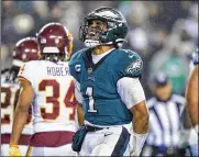  ?? MATT SLOCUM / AP ?? Eagles quarterbac­k Jalen Hurts ran for two touchdowns and threw for another, helping Philadelph­ia (7-7) rally from to beat virus-ravaged Washington 27-17 on Tuesday in a critical game with NFC playoff implicatio­ns. The game was reschedule­d due to WFT’s COVID issues.