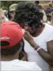  ??  ?? Gloria Darden, center, the mother of Freddie Gray, wipes away tears at a news conference held by Baltimore State’s Attorney Marilyn Mosby after prosecutor­s dropped remaining charges against the three Baltimore police officers who were awaiting trial in...