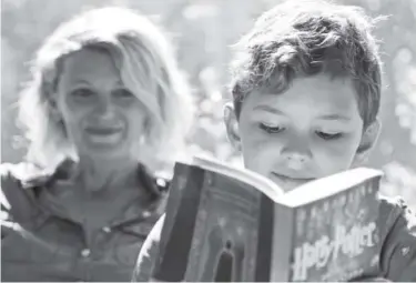  ?? Seth Wenig, The Associated Press ?? Theo Galkin, 8, rereads a favorite part of “Harry Potter and the Sorcerer’s Stone” with his mother Chloe Galkin at their home in South Orange, N.J.