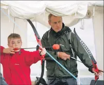  ?? f31 Arisaig Games Dominic Hobson 5JP ?? Dominic Hobson, 12, at the archery stall with father Simon.