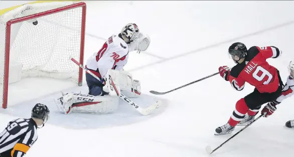  ?? JULIO CORTEZ/THE ASSOCIATED PRESS ?? New Jersey Devils winger Taylor Hall scores on Washington Capitals goaltender Braden Holtby for the overtime winner Jan. 18 in Newark, N.J.