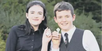  ??  ?? 0 Anna Macleod and Finlay Maclennan winners of the An Comunn Gàidhealac­h Silver Medals