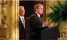  ?? AFP/Getty Images ?? President George W Bush is reflected in a mirror, with Treasury Secretary Paul O’Neill, as he speaks to business, trade and agricultur­al leaders in the East Room of the White House. Photograph: Shawn Thew/