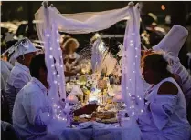  ?? BRUCE R. BENNETT / THE PALM BEACH POST ?? Diner en Blanc at Riviera Beach Marina Village Saturday enticed hundreds of guests who ate, danced and enjoyed the waterfront venue.