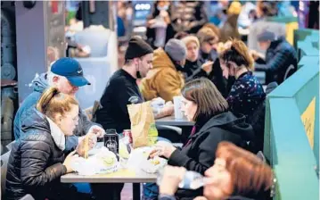  ?? MATT ROURKE/AP ?? Philadelph­ia lifted its vaccine restrictio­ns on indoor dining. Above, diners at the Reading Terminal Market.