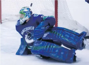  ??  ?? A shot from Nashville Predators centre Calle Jarnkrok sails past Vancouver Canucks goalie Anders Nilsson in Vancouver on Wednesday. The Canucks lost 7-1.