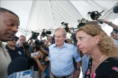  ?? The Associated Press ?? U.S. Sen. Bill Nelson, centre and congresswo­man Debbie Wasserman Schultz, right, were denied entry by security into the Homestead Temporary Shelter for Unaccompan­ied Children on Tuesday.