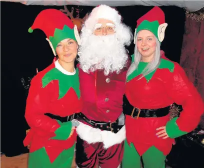  ??  ?? Santa and his elves helped bring some Christmas cheer to youngsters visiting their fathers at HMP Parc in Bridgend