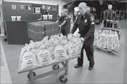  ??  ?? TENNESSEE RESIDENTS CASH IN: It’s like a modern day Gold Rush. Everyone’s scrambling to get their hands on the heavy, Jumbo Silver Ballistic Bags pictured above before they’re all gone. That’s because residents who find their zip code printed in today’s publicatio­n are cashing in on the lowest ever State Minimum price set for the next 2 days by the Federated Mint.