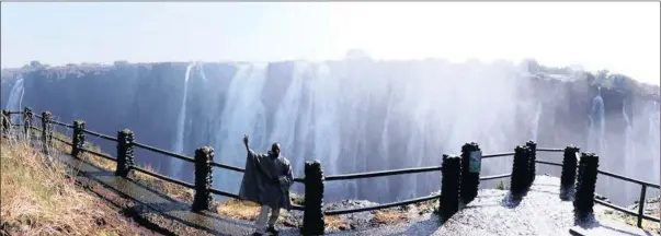  ??  ?? BREATHTAKI­NG: The majestic Victoria Falls, a pleasure to view from the Zambian side of the border too. Guide Babylon Mazuba stands at a lookout point.