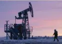  ?? — Reuters ?? A worker walks past a pump jack on an oil field owned by Bashneft in Bashkortos­tan, Russia.