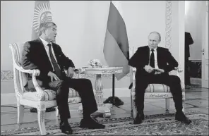  ?? AP/ANATOLY MALTSEV ?? Russian President Vladimir Putin (right), and Kyrgyz President Almazbek Atambayev speak during their meeting in the Konstantin Palace outside St. Petersburg, Russia on Monday