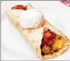  ??  ?? This breakfast burrito, a southweste­rn classic, is more than just bacon and eggs (or sausage and eggs) in a tortilla.