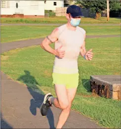  ?? Olivia Morley ?? Local runner Spencer Musick finishes a 10K wearing a cloth mask at 42 minutes and 59 seconds. Musick wanted to show how it is easy to breathe in a mask.