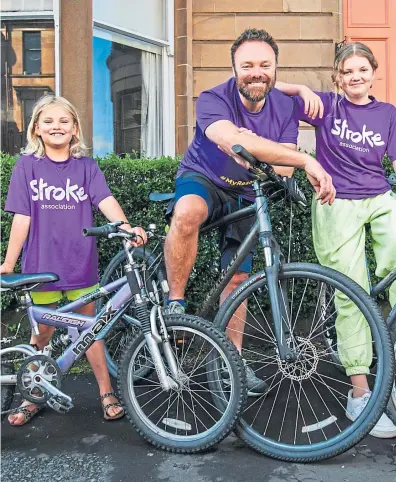  ??  ?? ● Stephen and daughters Elsa and Thea who are cycling to raise funds for the Stroke Associatio­n