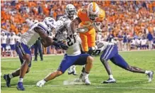  ?? AP PHOTO/WADE PAYNE ?? Tennessee running back Jaylen Wright (20) leaps for the end zone as he’s tackled by Akron linebacker Bubba Arslanian (27), defensive back KJ Martin (15) and linebacker Bryan McCoy (40) during the second half of Saturday night’s game in Knoxville. Tennessee won 63-6.